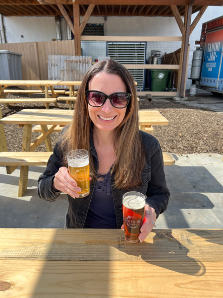 Christine with beer at Diatribe Brewing
