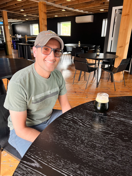 Tom with beer at TRVE Brewing Co.