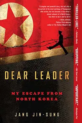 Dear Leader by Jang Jin-sung book cover with red and gold image of North Korean symbol with barbed wire and soldier
