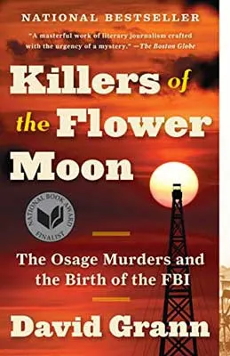 Killers Of The Flower Moon by David Grann book cover with yellow moon in orange red sky