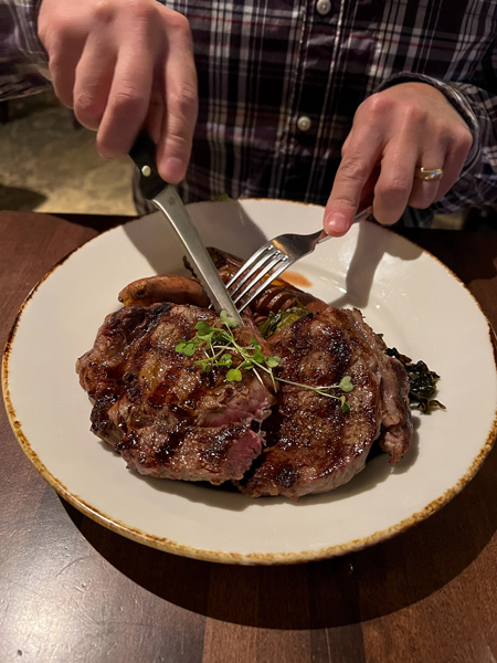 Tom cutting steak at Village Social