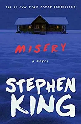 Misery by Stephen King book cover with snow with blue tint at night and house with lights on in background