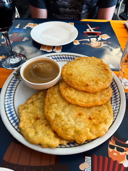 Bavaria German Restaurant Aruba with four gluten-free potato pancakes on white and blue plate with apple sauce
