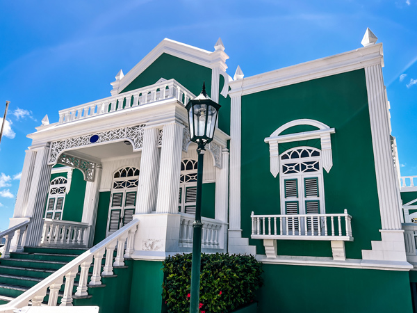 Green restored historic building with white trim in Oranjestad, Aruba
