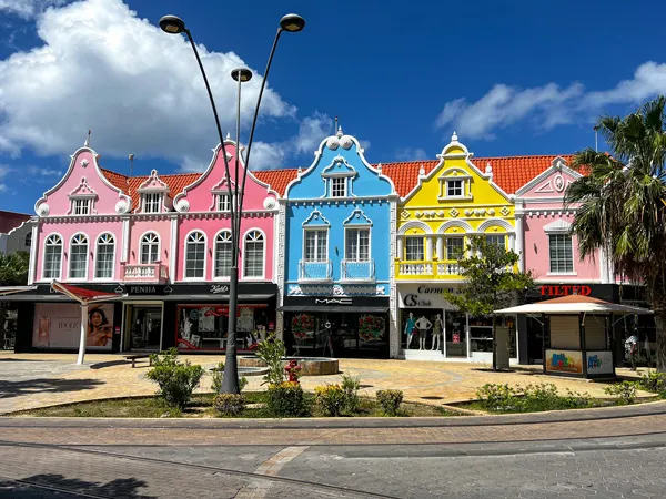 Colorful buildings - pink, red, blue and yellow with white trim - with Dutch-style architecture in Oranjestad, Aruba