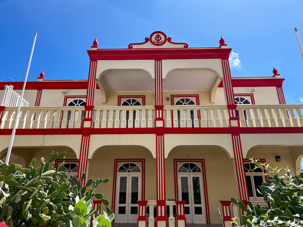 Oranjestad Aruba Architecture with cream colored two story building with ornate reddish orange trim