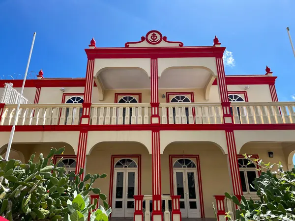 Oranjestad Aruba Architecture with cream colored two story building with ornate reddish orange trim