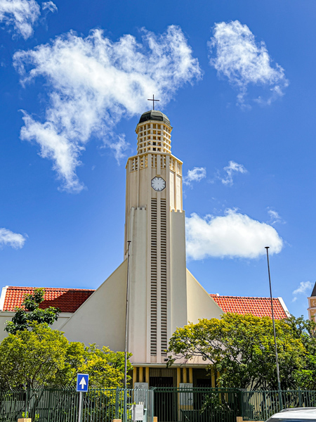 Protestant Church in Oranjestad Aruba with circular tower-like church and blue partly cloudy sky