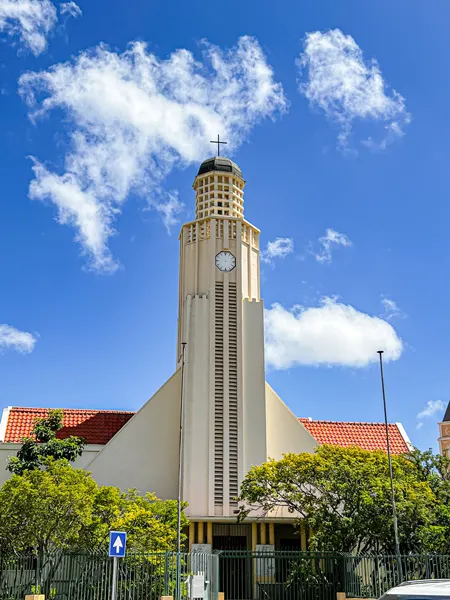 Protestant Church in Oranjestad Aruba with circular tower-like church and blue partly cloudy sky