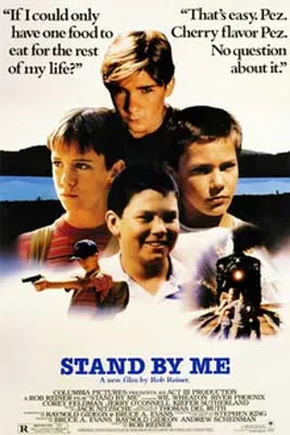 Stand By Me Movie Poster with image of four dark haired young boys and train with black steam along the bottom