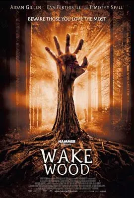 Wake Wood Movie Poster with image of hand shooting out of ground with rays of light around it