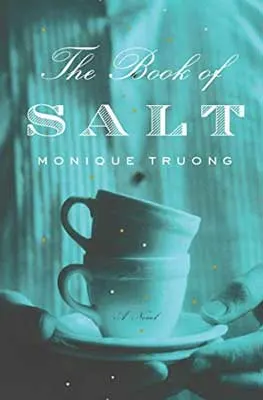 The Book of Salt by Monique Truong book cover with person holding two stacked teacups and blue tint