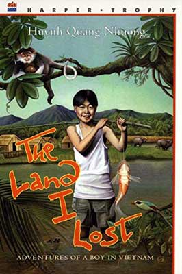 The Land I Lost: Adventures of a Boy in Vietnam by Quang Nhuong Huynh, Illustrated by Vo-Dinh Mai book cover with young person in white top and mountain, lake, and tree landscape behind them