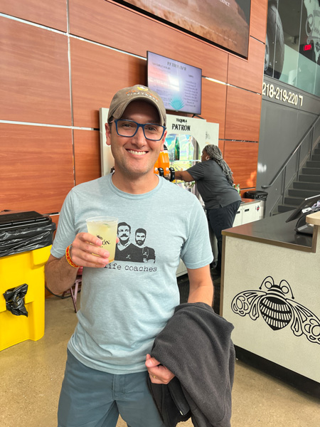 Tom holding a mixed drink at the Bon Secours
